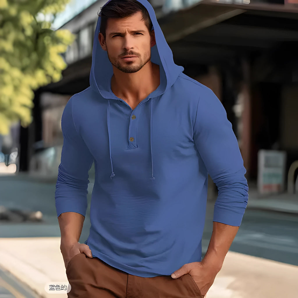 A dark blue cotton pullover hoodie with long sleeves on a hanger.