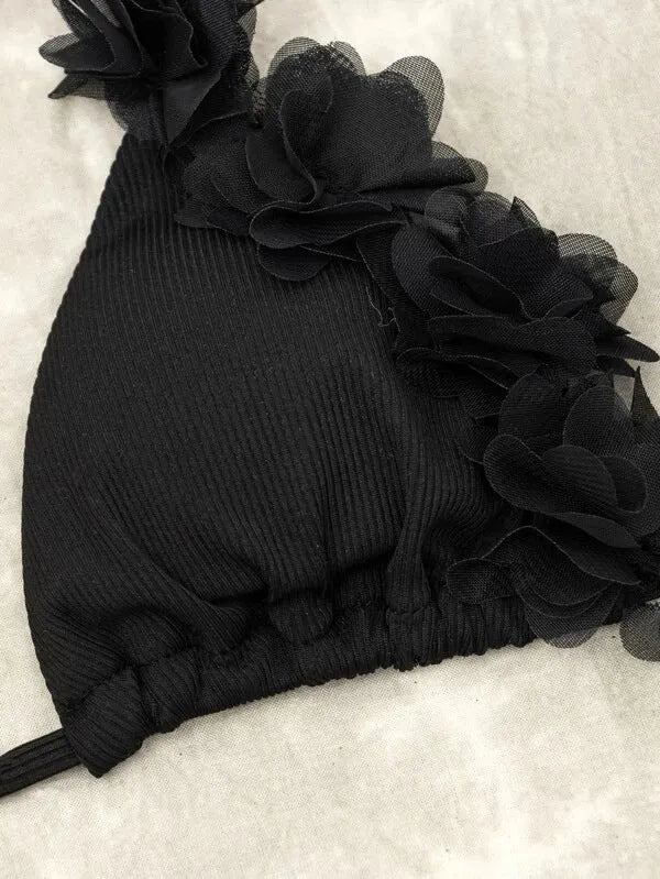 Black polyester swimwear two-piece set with a gathered design, showing the top and matching shorts.