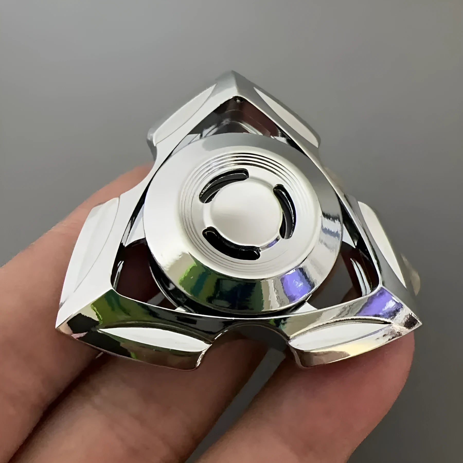 A silver and a colourful alloy metal fingertip decompression gyro spinner toy.