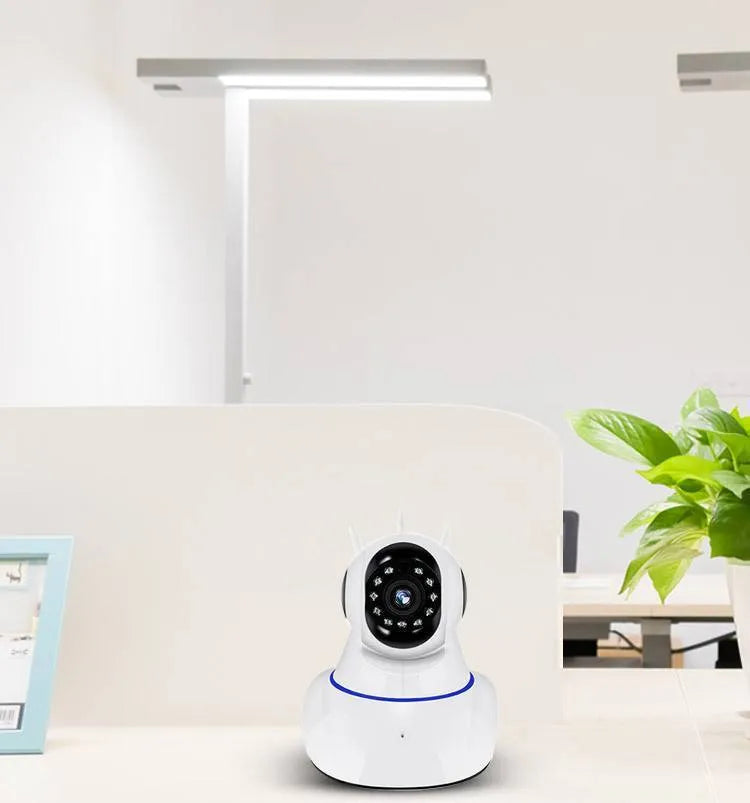 White wireless dome security camera on a stand showing the lens and housing.