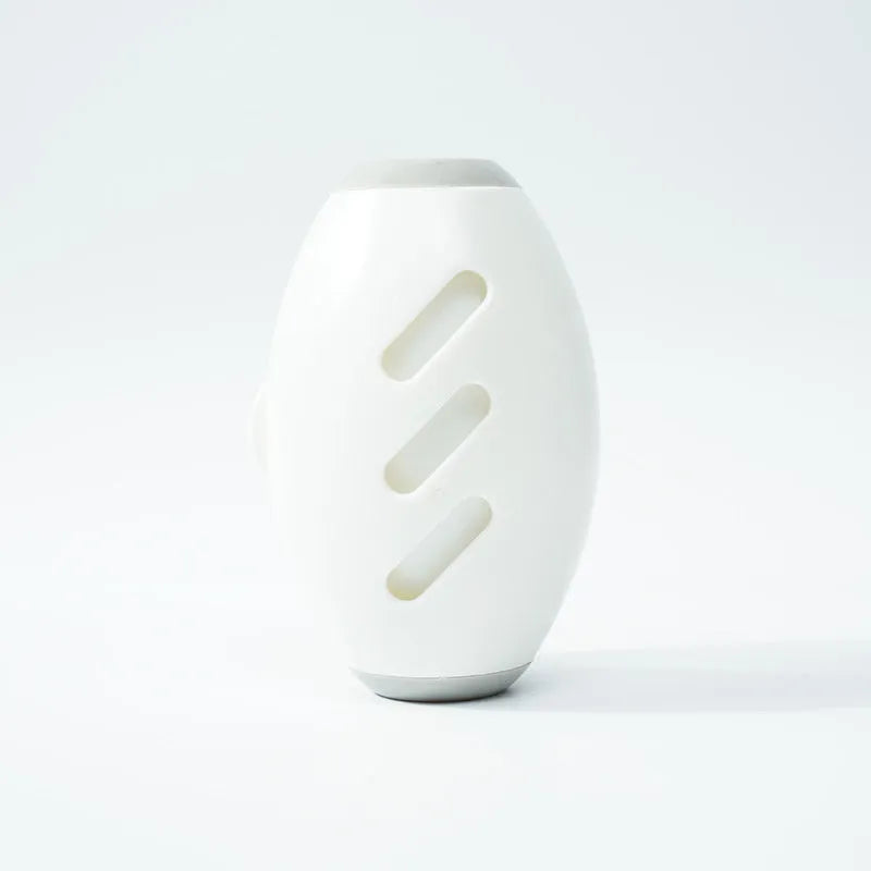 Green and white reusable gel lint roller ball for removing pet hair and lint from clothes.