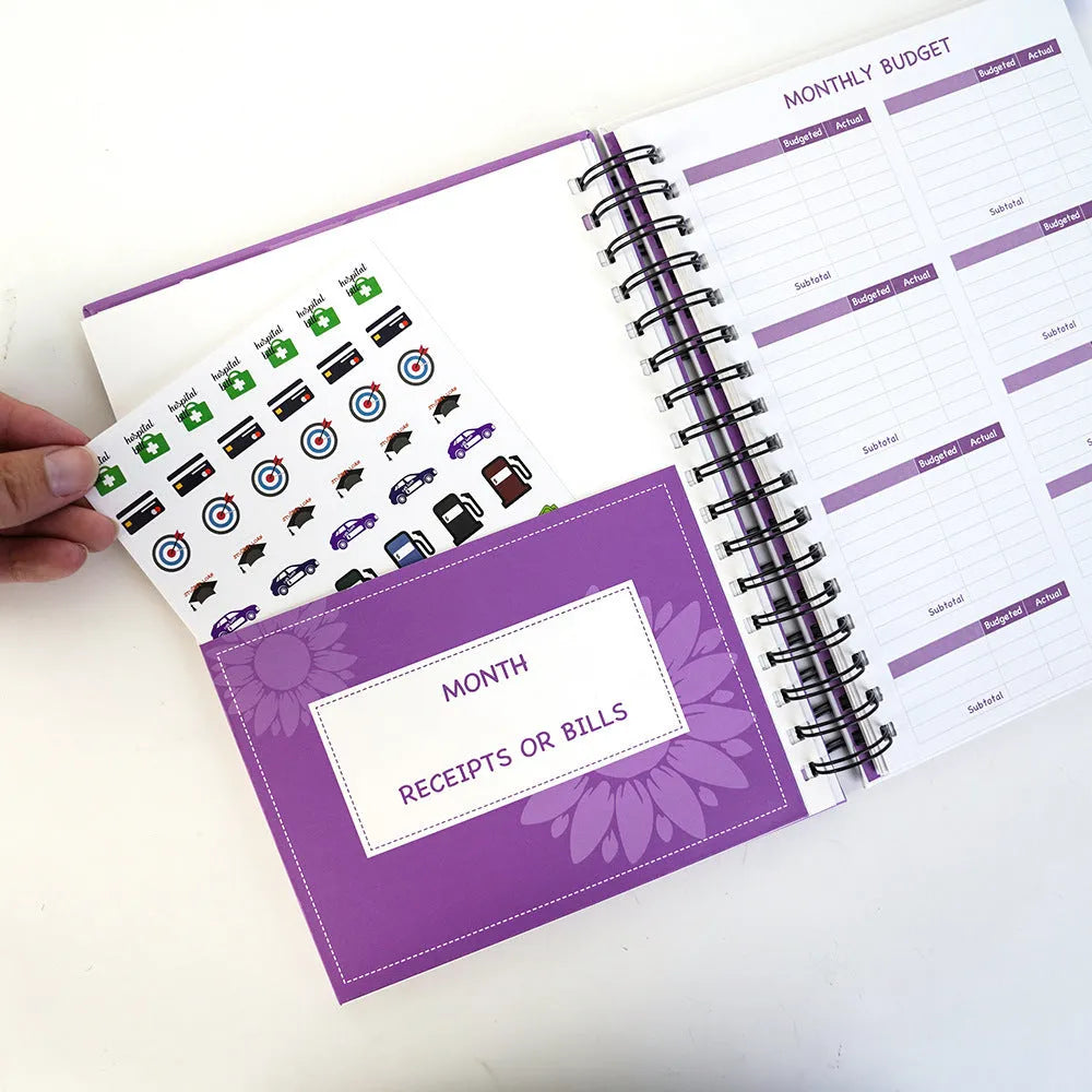 Purple A4 coil notebook for financial planning with stickers, pen, and paper clips