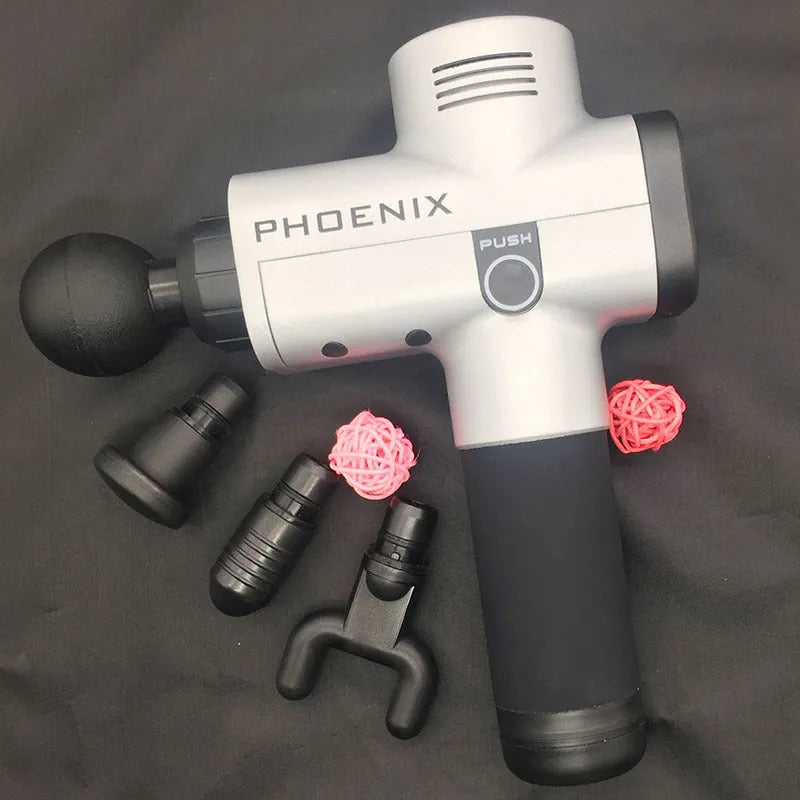 Black ABS fascia massage gun with four different coloured attachment heads on a grey surface.