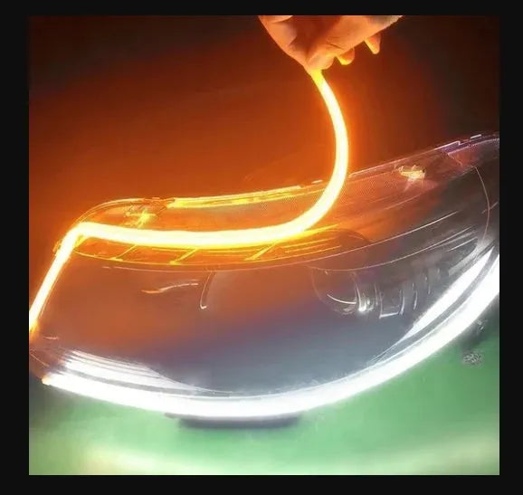 60cm ultra-thin car LED tear light guide strip in white yellow two-colour mode on a dark background