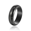 Glossy electroplated titanium steel ring in gold colour on a grey background.