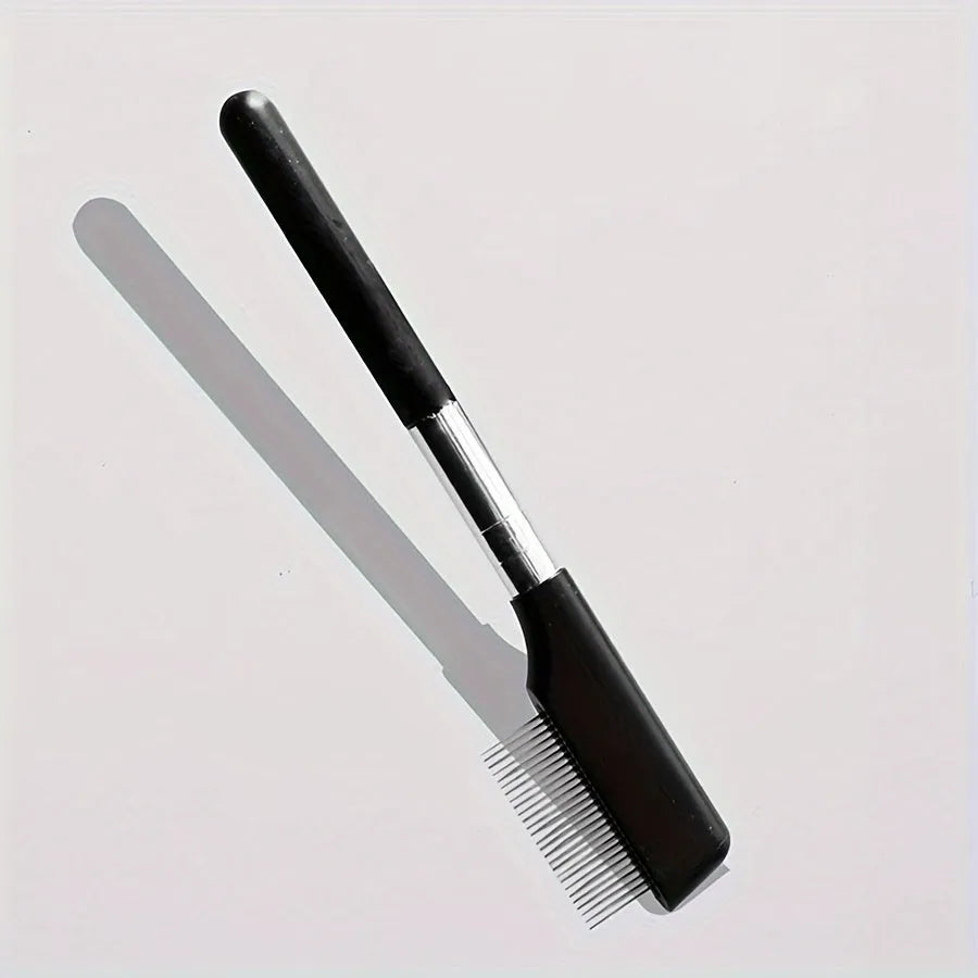 Black ambidextrous pet grooming brush with soft rubber bristles for gentle eye cleaning and hair removal on dogs and cats.