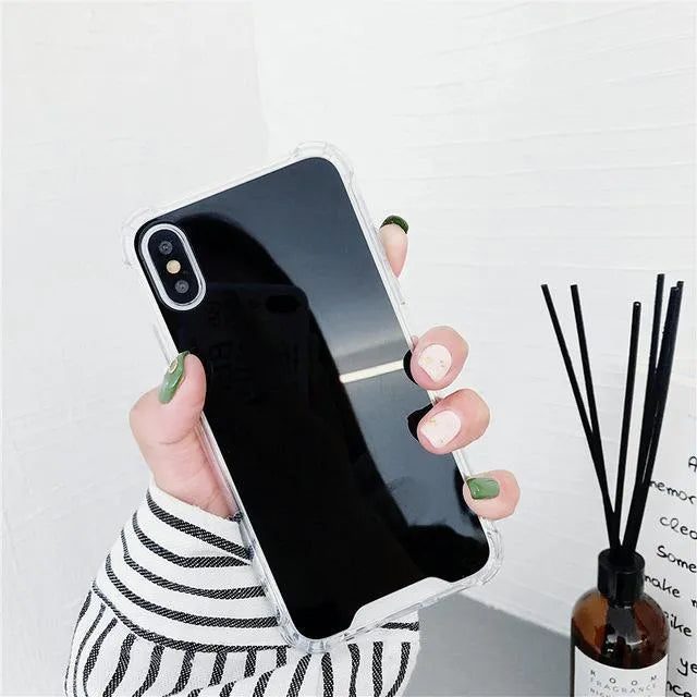 TPU mirror phone case for iPhone on a table, showing anti-fingerprint finish.