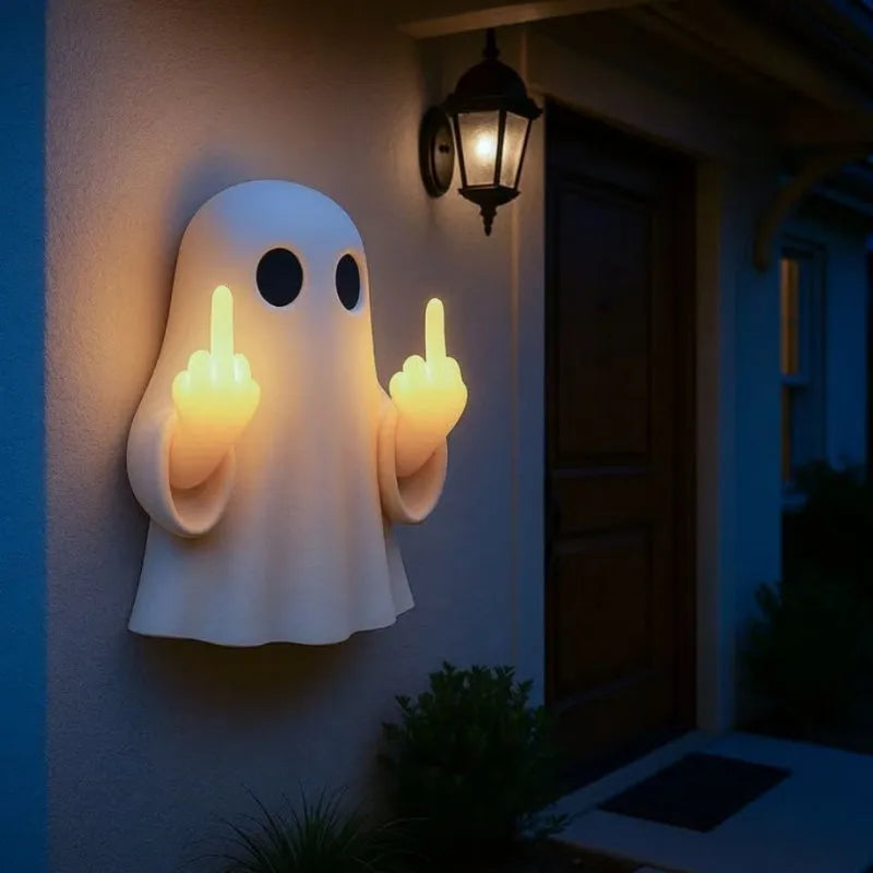 White cute ghost statue plastic night lamp for Halloween decoration on a dark surface.