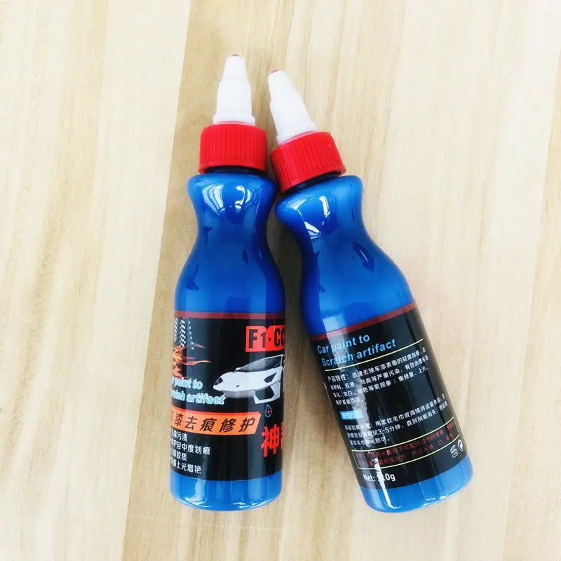 Blue automotive scratch repair agent kit with bottle and applicator for vehicle paint touch-up