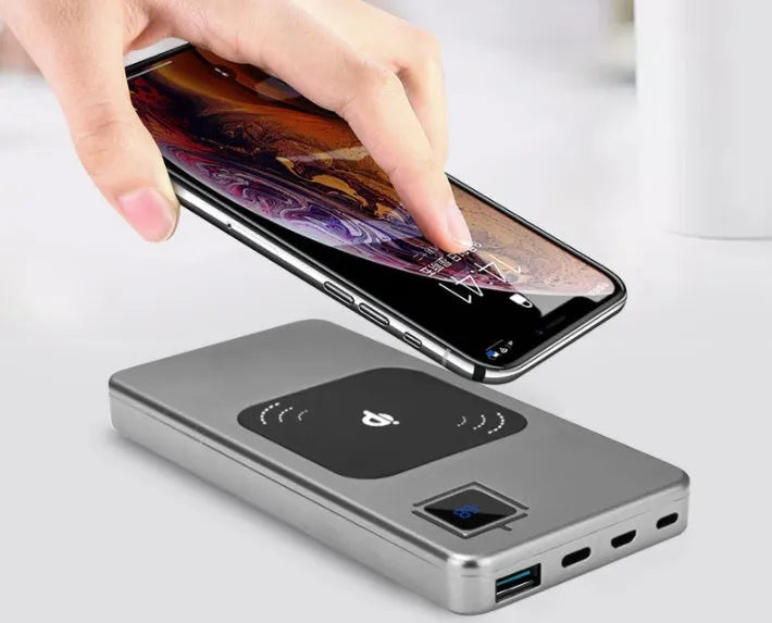 Black portable power bank with LCD display showing battery level.