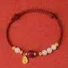 Handmade women's bracelet with cinnabar red rope, 925 silver, and Hetian jade on an adjustable chain.