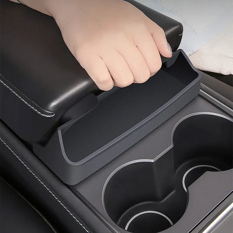 Black silicone glasses case installed inside a Tesla Model 3 or Y centre console armrest.