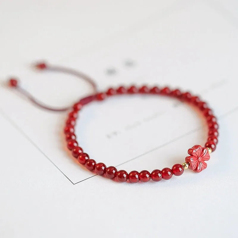 Hand-woven natural red agate bracelet showing diamond-shaped beads in ethnic woven pattern