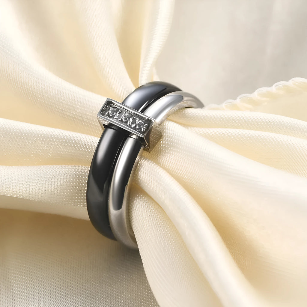 Steel black zirconium ceramic women's ring with 6mm wide band and glossy round inlay detail on a finger.