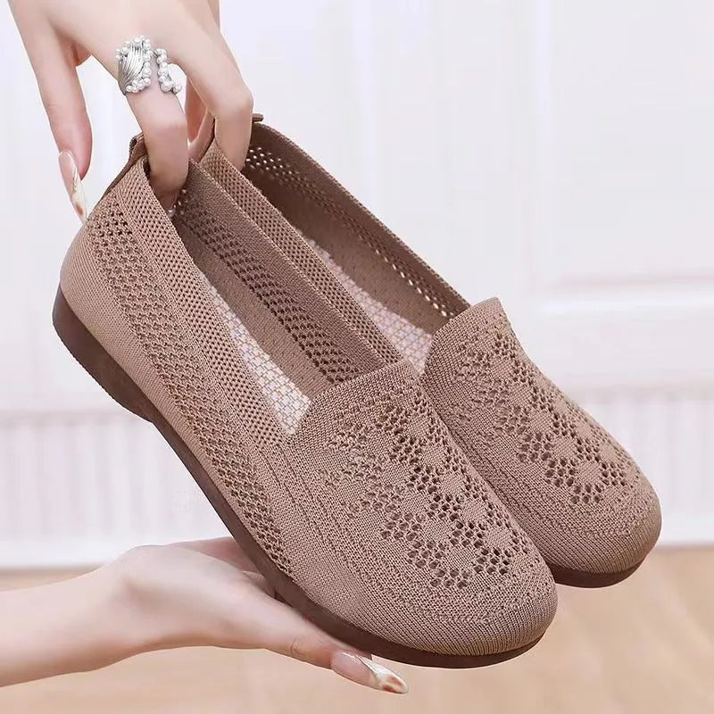 Beige casual tennis shoes for women with mesh upper and antiskid sole on a plain background.