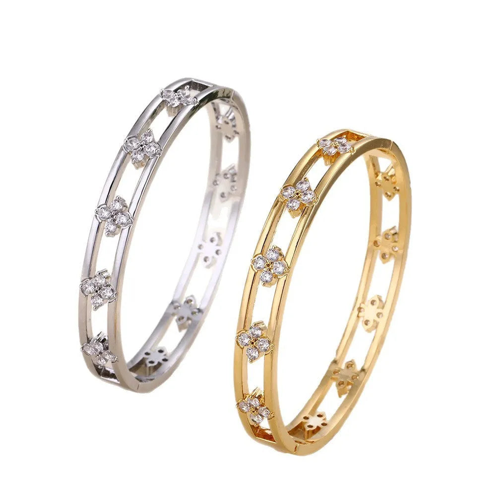 Hollow women's bracelet with four-leaf clover charm containing inlaid AAA zircon gemstones