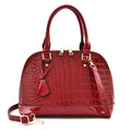Large shiny black PU leather crossbody bag with shell-shaped design showing interior organisation.