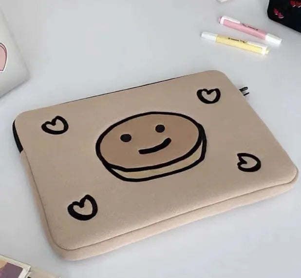 Embroidered animal design laptop sleeve in polyester, shown next to a laptop.