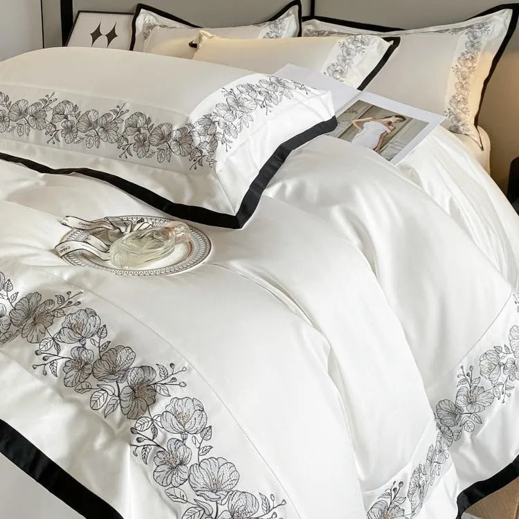 120 thread count pure cotton embroidered four-piece bedding set in solid grey colour on a bed