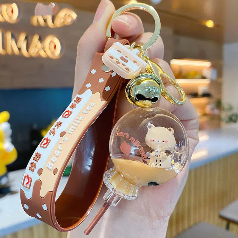 Oil-infused pearl milk tea bear acrylic alloy keychain pendant in mug style on a pink background