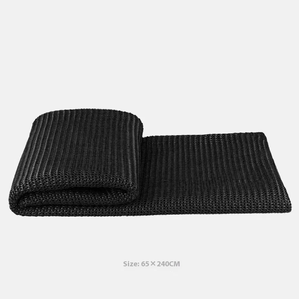 Modern minimalist grey and white plaid polyester bed runner with dark grey pillowcase and round leather pillow on bed