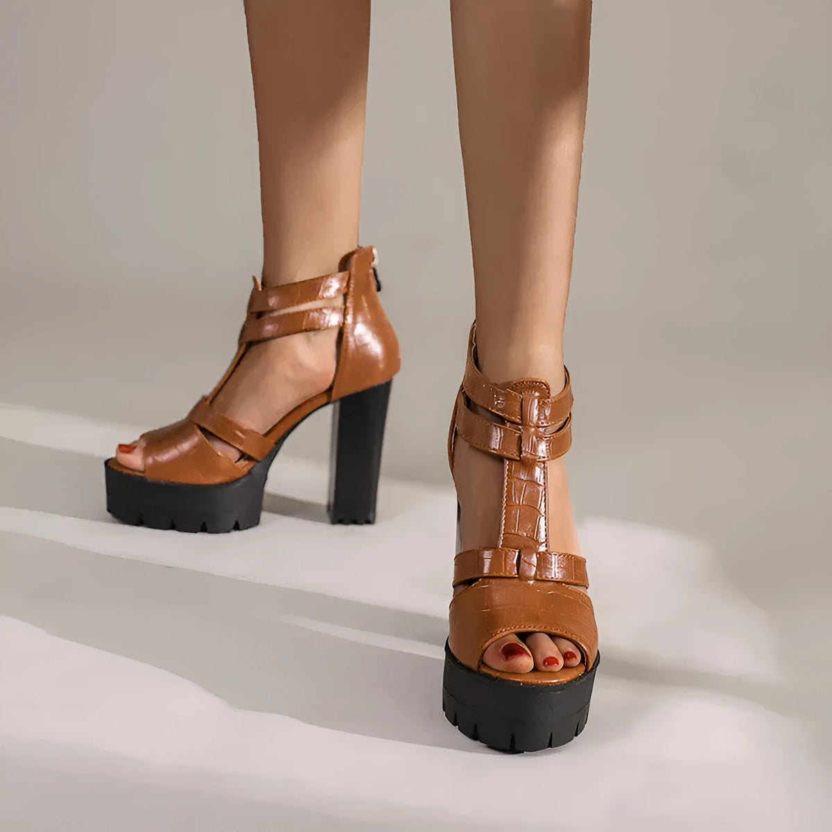 Women's black platform high heel sandals with round toe and back zip fastening.