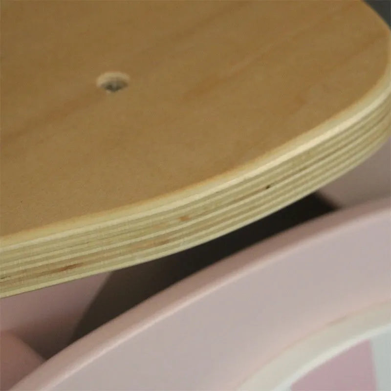Pink wooden balance scooter for toddlers and children with 10-inch wheels.