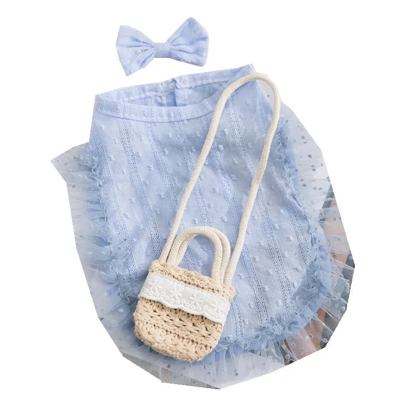 Two-tone sleeveless pet outfit in yellow or blue with ruffles, matching bow and small woven crossbody bag.