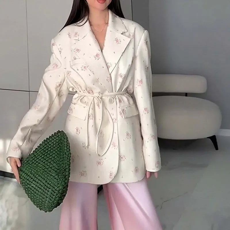 Women's white suit jacket with a lace-up detail on the collar and an adjustable waist tie, shown in a regular fit with long sleeves.