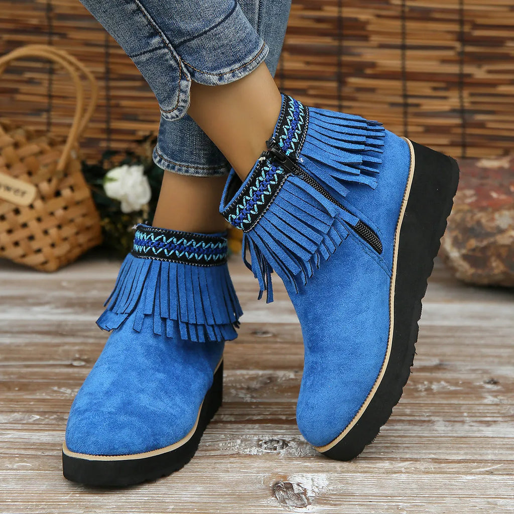Women's black suede wedge ankle boots with side zip and tassel detail on a waterproof platform sole.