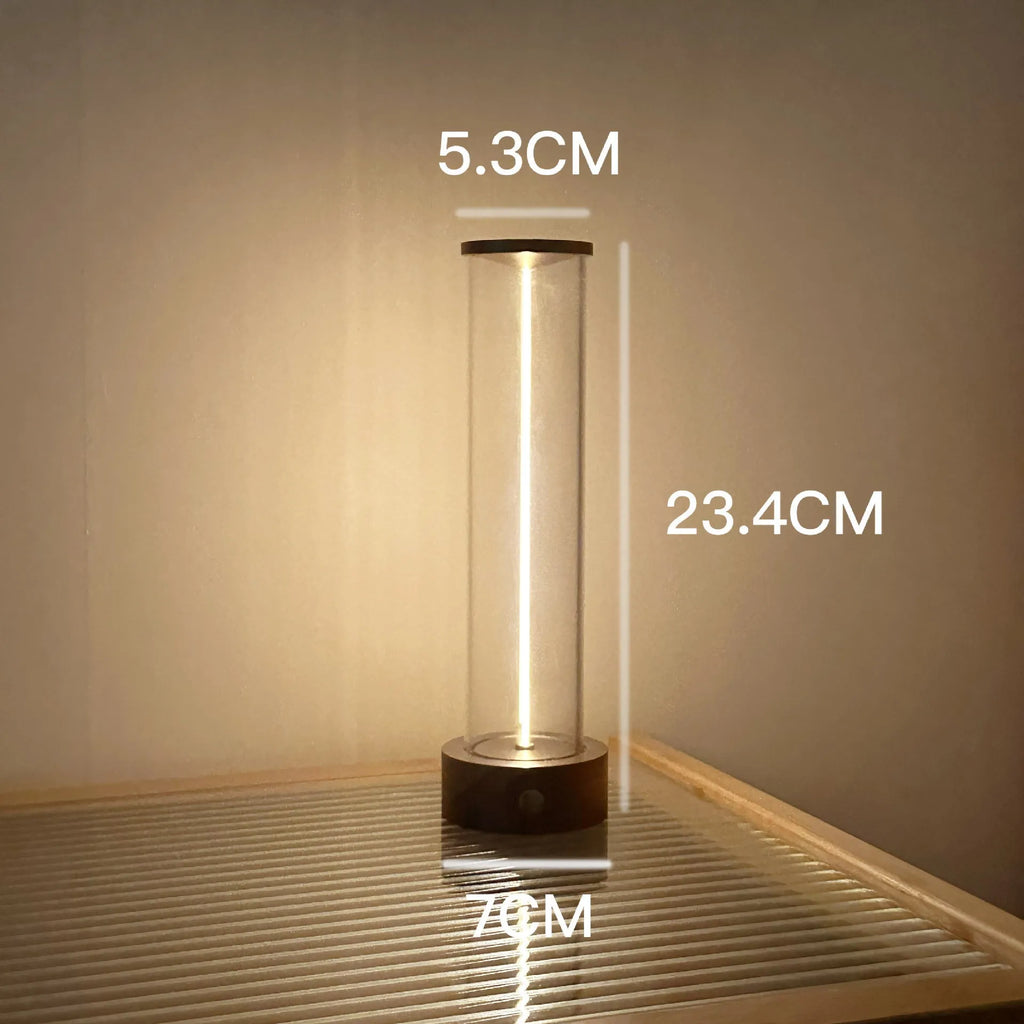 Slim modern glass LED bar night light with magnetic base on a desk surface.