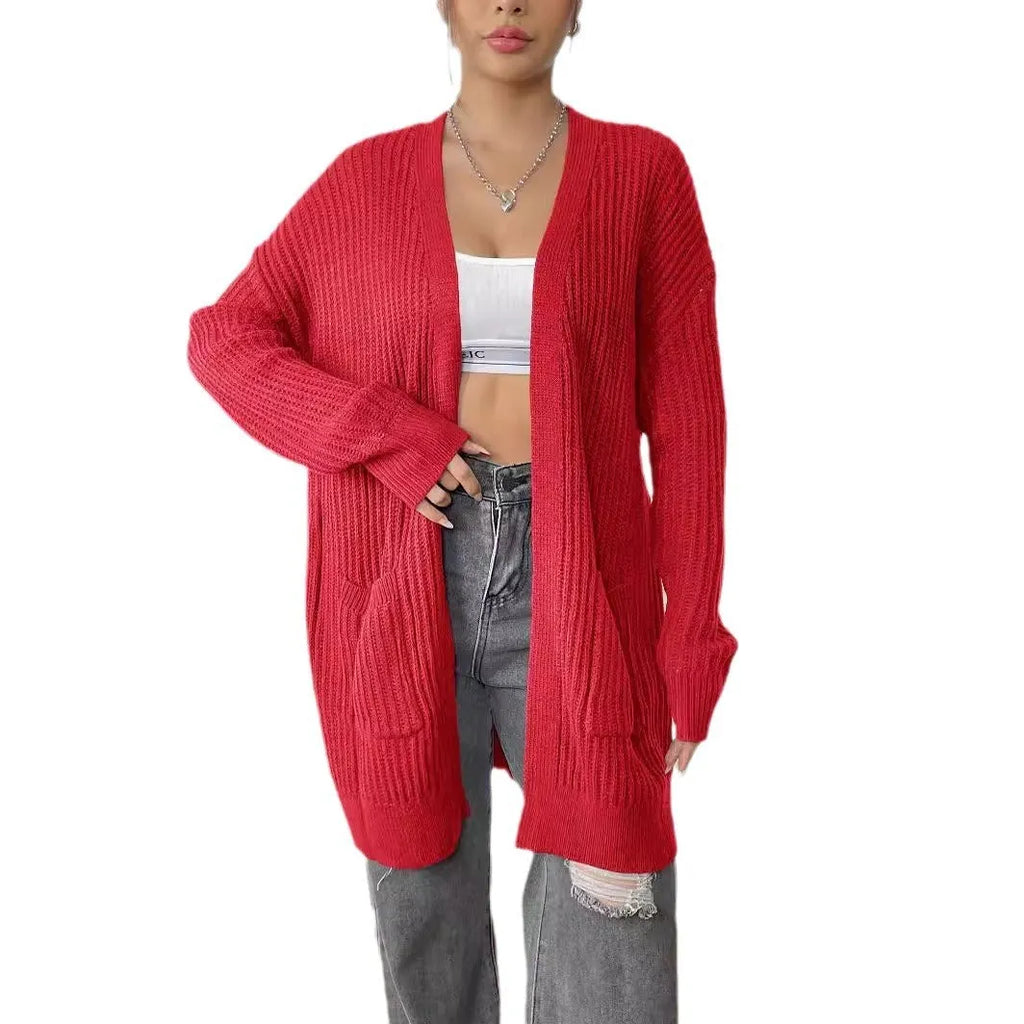 Women's dark green loose-fit acrylic knit cardigan with long sleeves on a hanger.