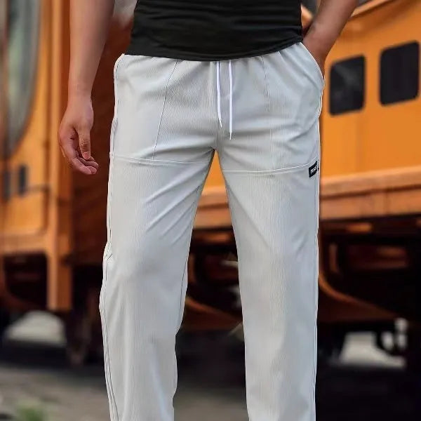 Men's light grey polyester casual trousers for spring and autumn wear.