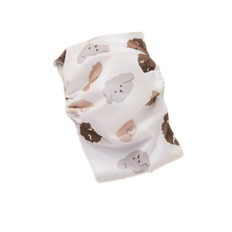 Reusable cartoon bone print dog diaper with fastener tape and elastic waistband, shown in blue bear pattern.