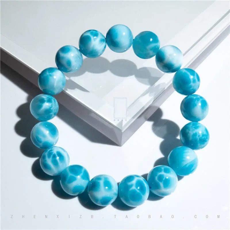 Blue hand-crafted bodhi bracelet with a pearl accent, showing bead sizing options.