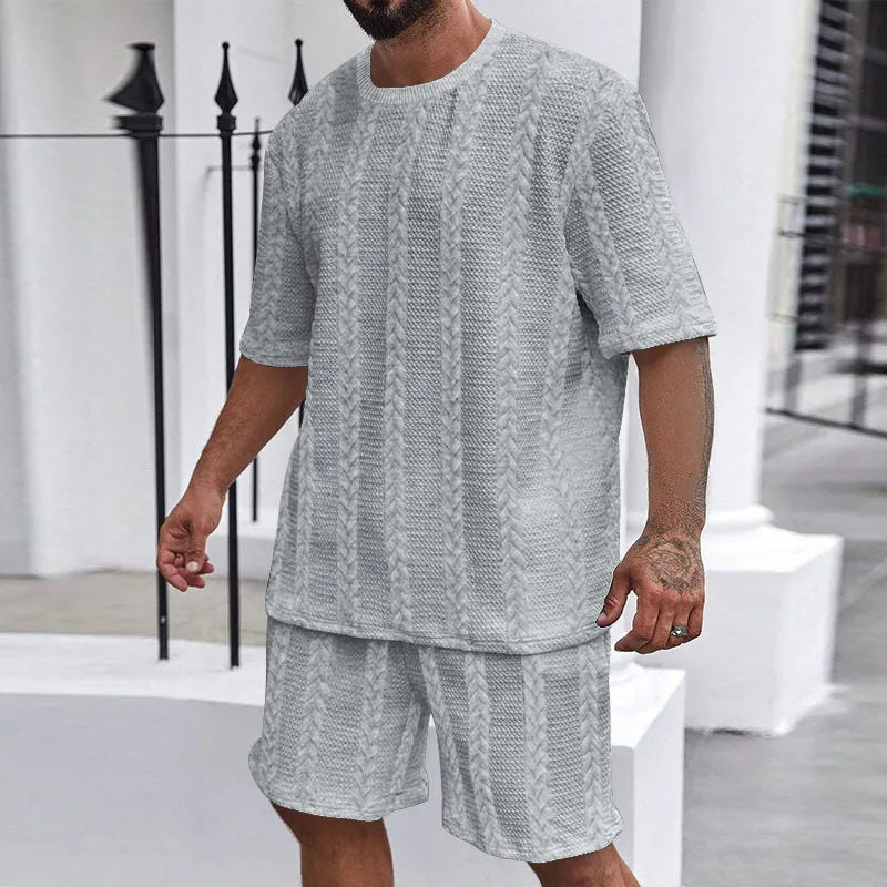 Men's wheat grain tassel knit two-piece set: grey hooded sweatshirt and matching shorts, front view on model