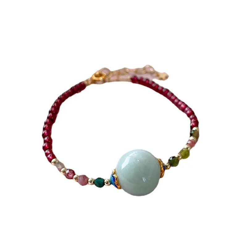 Aquamarine garnet bracelet with drop-shaped tourmaline centrepiece on wrist