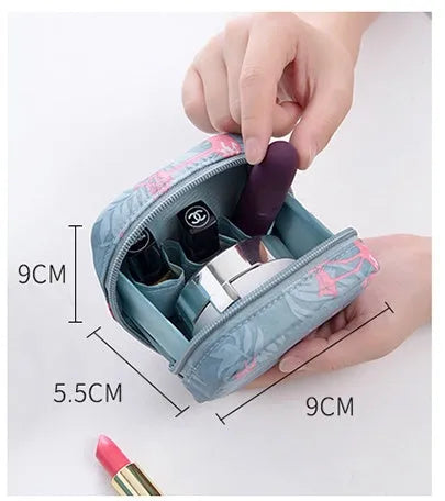 A blue cloth cube-shaped makeup storage bag with a plain pattern, shown closed.