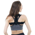 Black adjustable posture correction strap showing breathable construction and adjustable mechanism