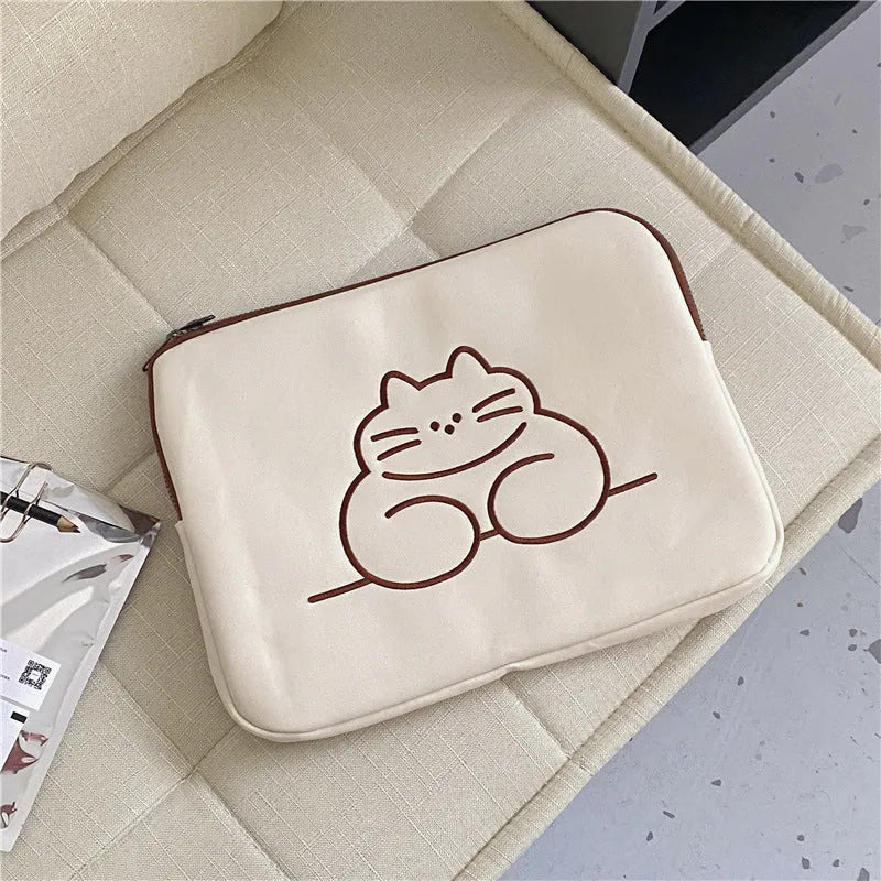 Embroidered fat cat design on a grey nylon tablet protective sleeve with a black metal zipper.