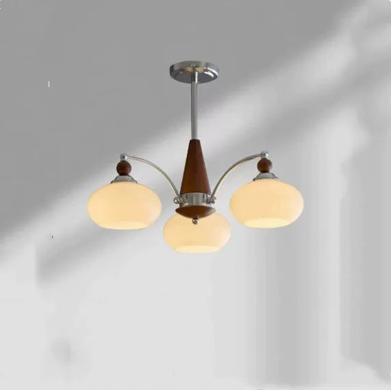 Persimmon glass chandelier with multiple chrome lampshades in a Middle Ancient style, hung from a ceiling.