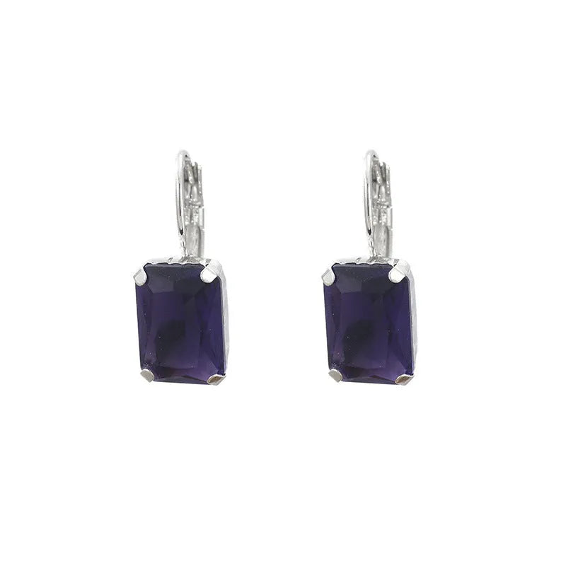 Square-shaped copper earrings with crystal decoration in red, yellow, or purple colours.