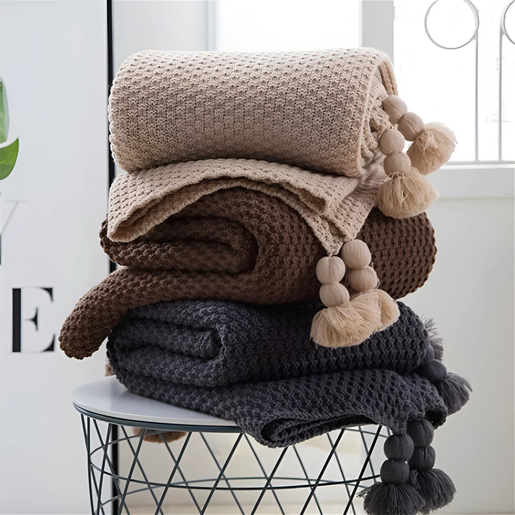 Nordic fringed knit ball acrylic throw blanket in beige on sofa, 130x170cm size