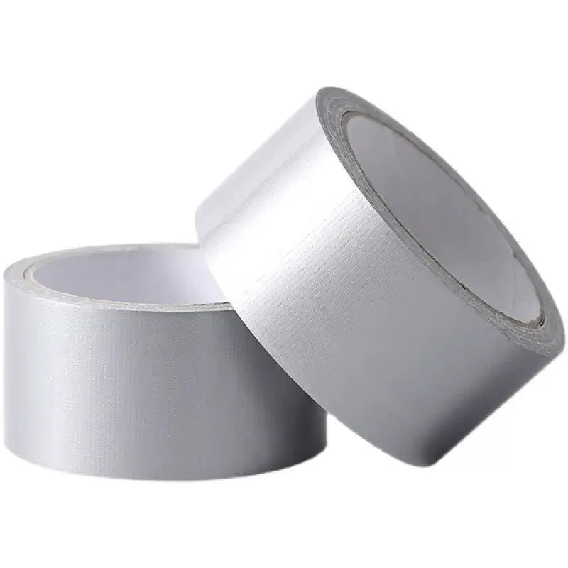 Roll of high-adhesion windproof sealing tape in transparent colour on a windowsill.