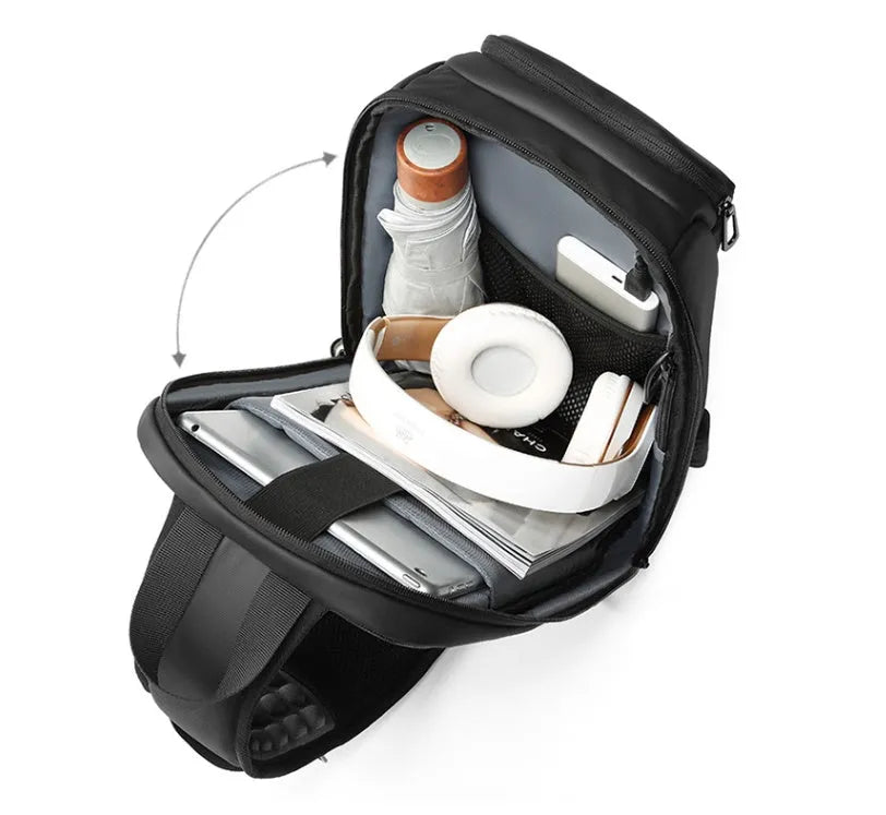 Black square vertical PVC shoulder bag showing organiser pockets and air cushion strap.