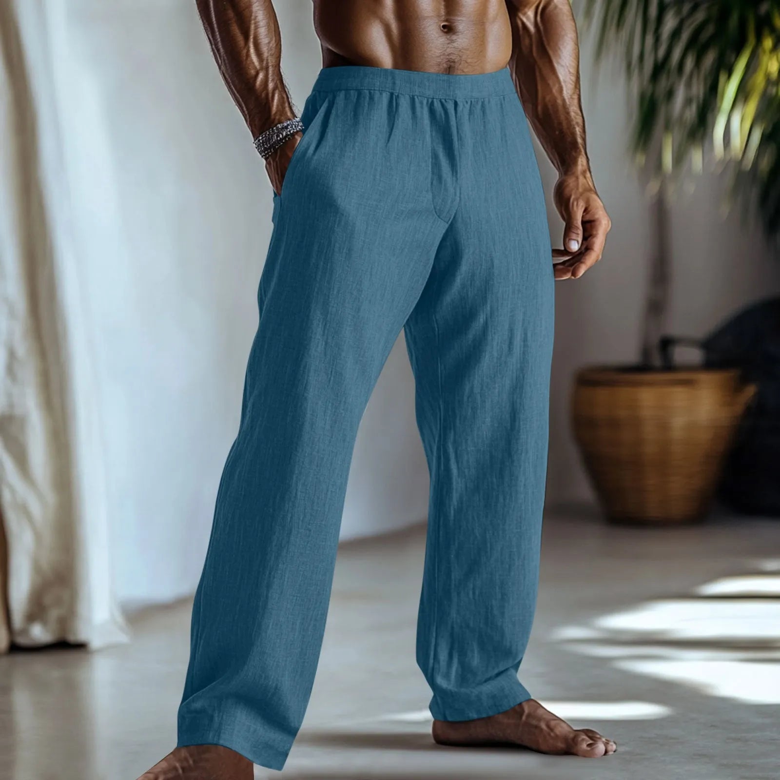 Straight leg cotton linen trousers in light apricot colour on a hanger.