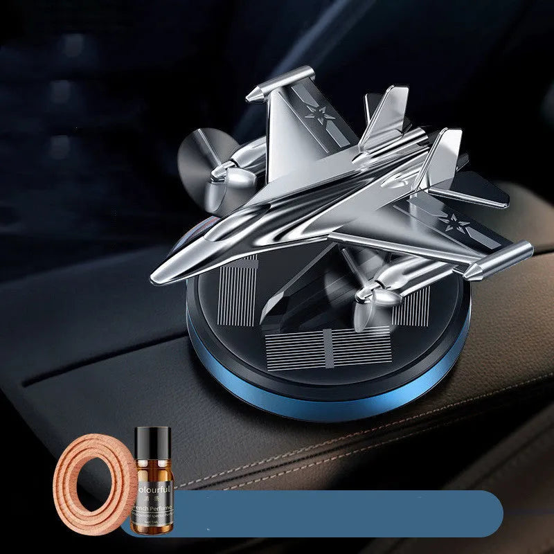 Solar powered rotating fighter aircraft perfume ornament in silver, gold, blue, or red colour.