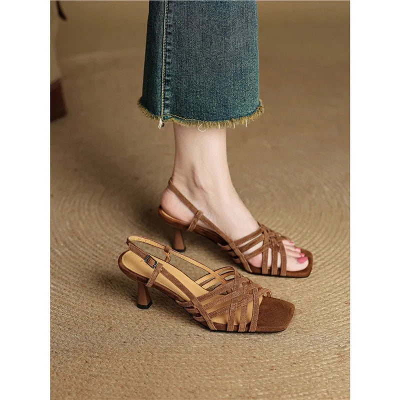 Beige retro women's sandals with thin crossing straps, an ankle buckle, and a 3-6cm mid-heel on a rubber sole.