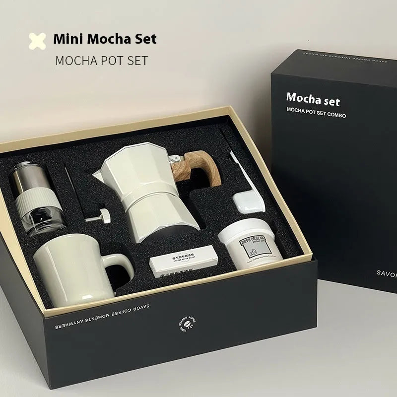 Six-piece manual grinding machine set in beige and black with moka pot, cup, bean jar, and accessories