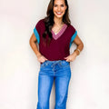 Burgundy women's loose V-neck sweater with cuffed short sleeves and contrast trim detail